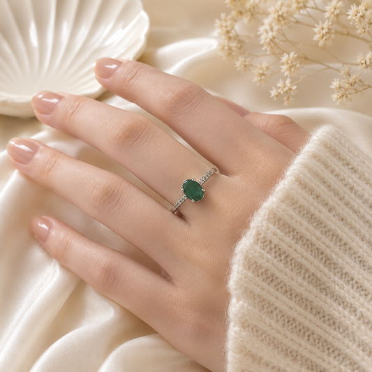 Oval Emerald Solitaire Ring crafted in 925 Sterling Silver with a green oval cut Emerald gemstone and side accents.