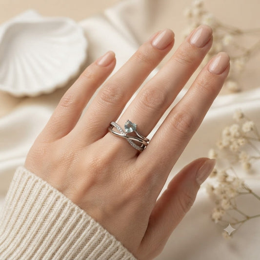 Heart Blue Topaz Ring crafted in 925 Sterling Silver with a heart cut sky blue gemstone and crossover pavé band.