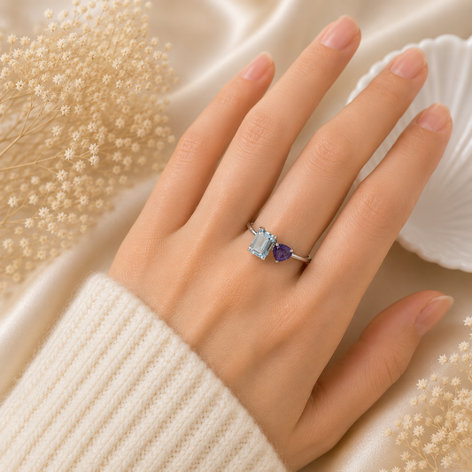 Open Blue Topaz Ring crafted in 925 Sterling Silver with an emerald cut sky blue Blue Topaz and heart-shaped purple accent gemstone.