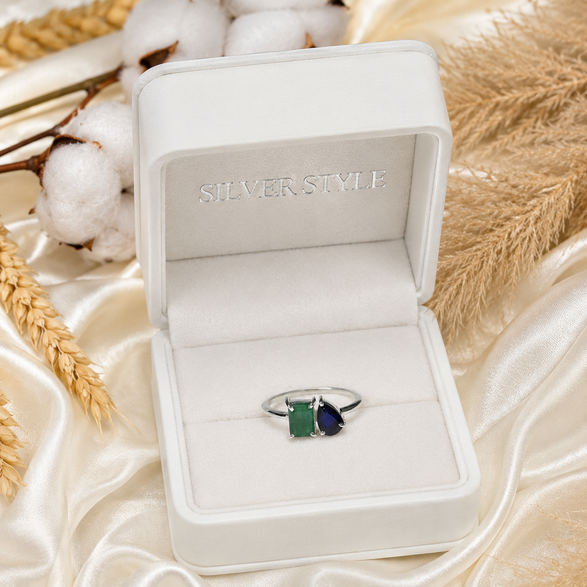 Emerald and Sapphire Ring crafted in 925 Sterling Silver with green and blue gemstones.
