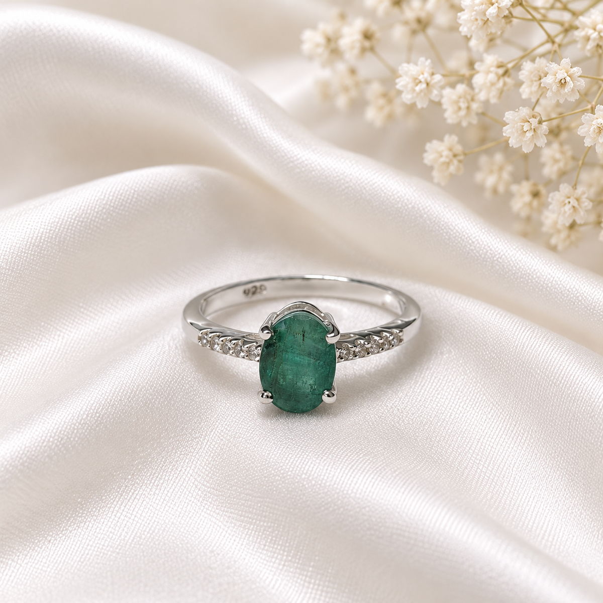 Oval Emerald Solitaire Ring crafted in 925 Sterling Silver with a green oval cut Emerald gemstone and side accents.