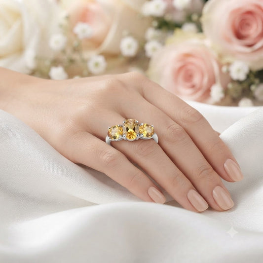 Three Stone Citrine Ring crafted in 925 Sterling Silver featuring three oval cut Citrine gemstones.