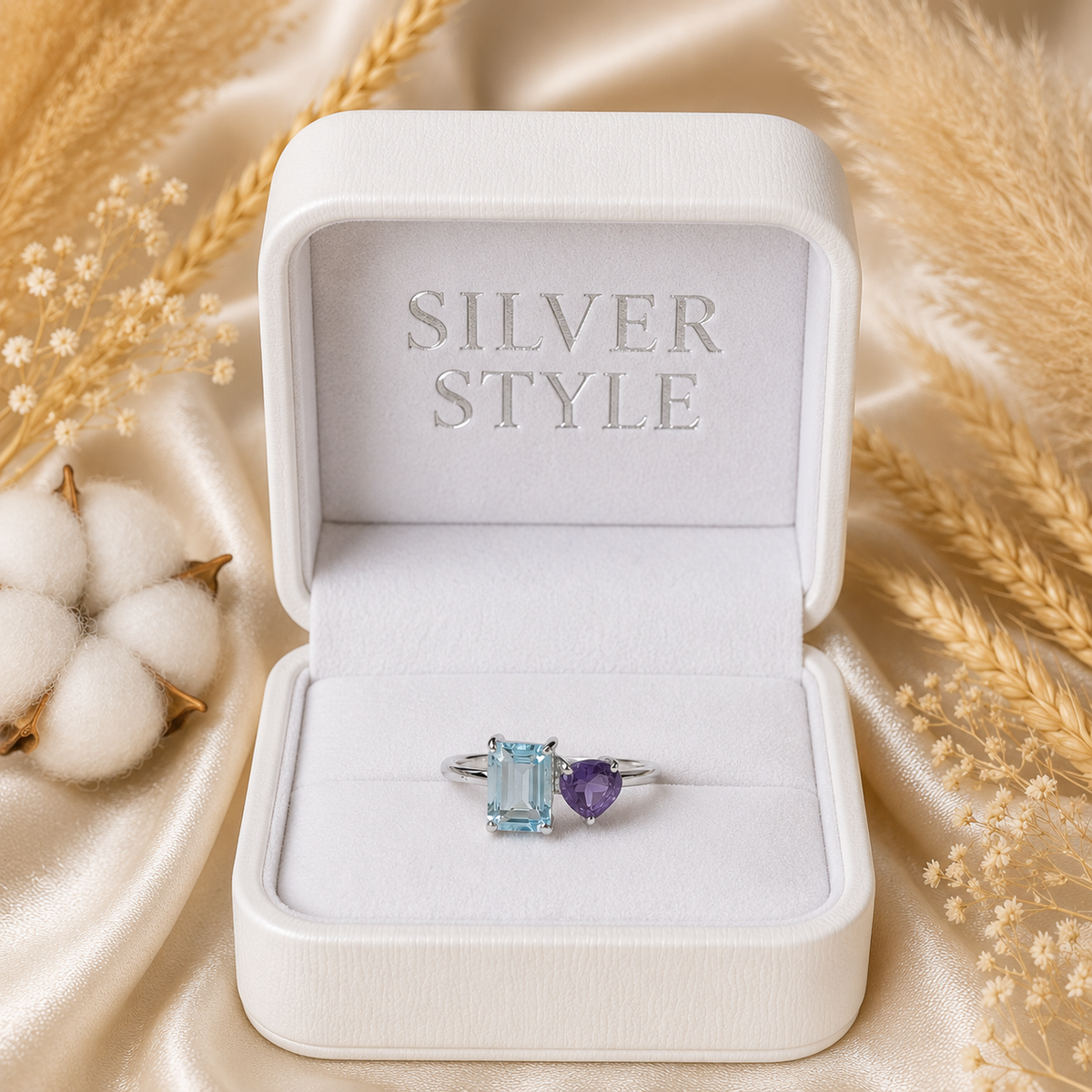 Open Blue Topaz Ring crafted in 925 Sterling Silver with an emerald cut sky blue Blue Topaz and heart-shaped purple accent gemstone.