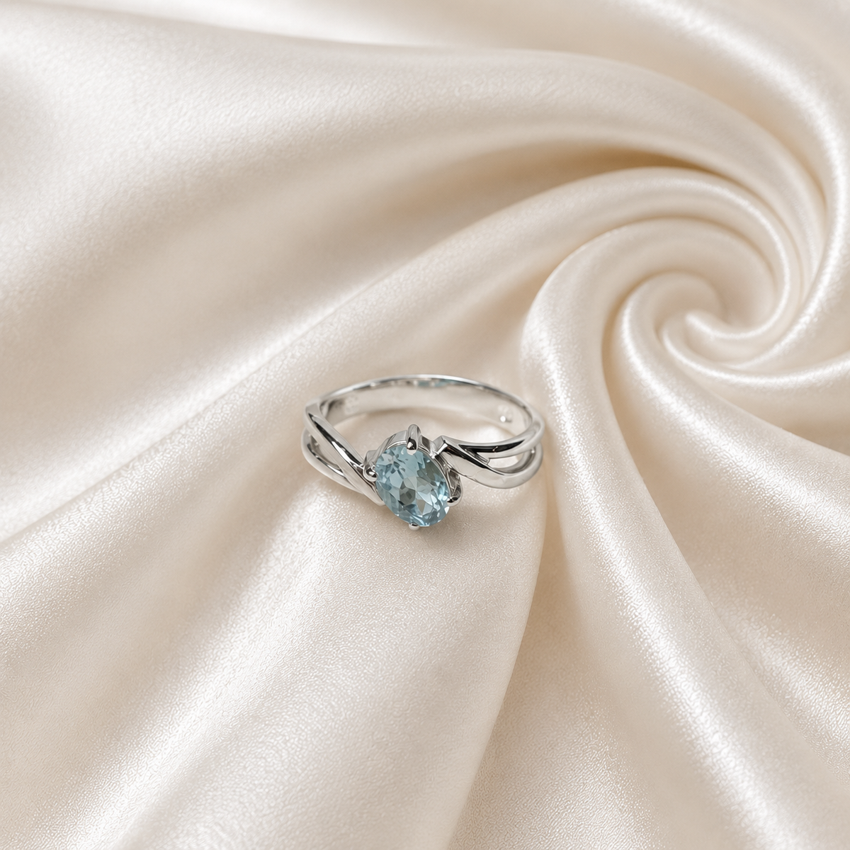 Oval Blue Topaz Ring crafted in 925 Sterling Silver with an oval cut sky blue gemstone in a four-prong setting and split shank design.