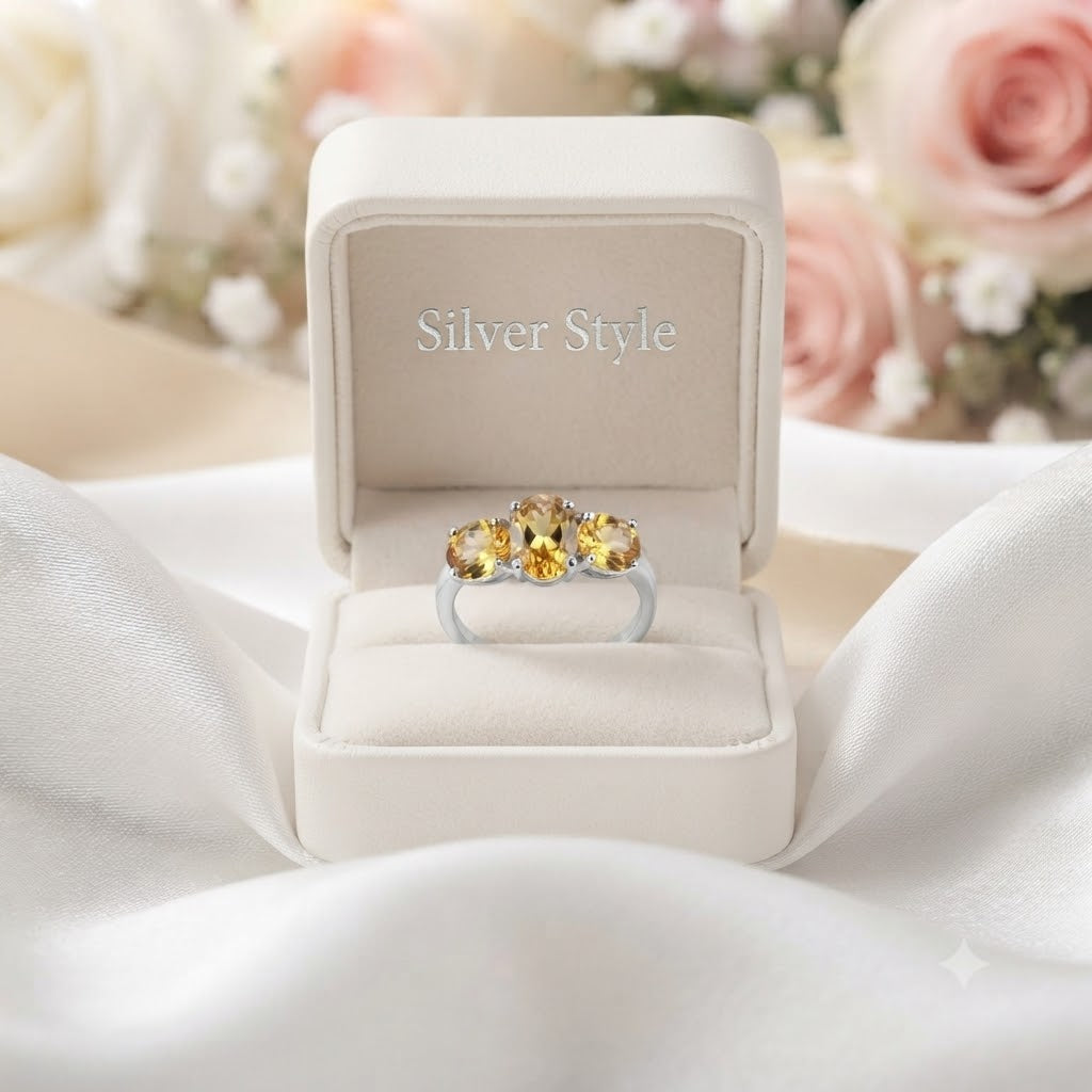 Three Stone Citrine Ring crafted in 925 Sterling Silver featuring three oval cut Citrine gemstones.