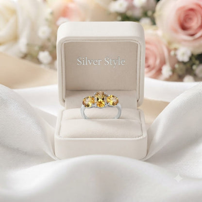 Three Stone Citrine Ring crafted in 925 Sterling Silver featuring three oval cut Citrine gemstones.