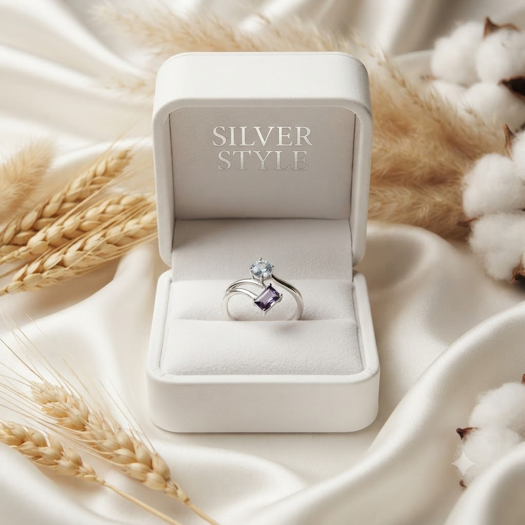 Open Amethyst and Blue Topaz Ring crafted in 925 Sterling Silver featuring an emerald cut Amethyst and pear cut Blue Topaz gemstone.