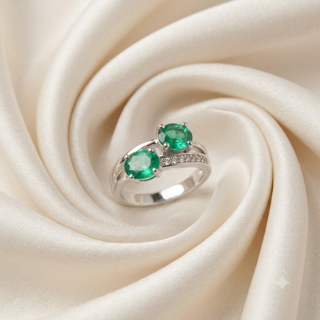 Twin Emerald Ring crafted in 925 Sterling Silver with two green Emerald gemstones.