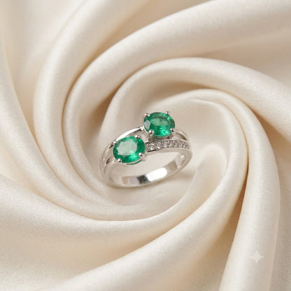 Twin Emerald Ring crafted in 925 Sterling Silver with two green Emerald gemstones.
