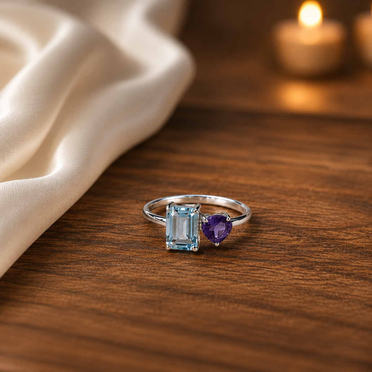 Open Blue Topaz Ring crafted in 925 Sterling Silver with an emerald cut sky blue Blue Topaz and heart-shaped purple accent gemstone.