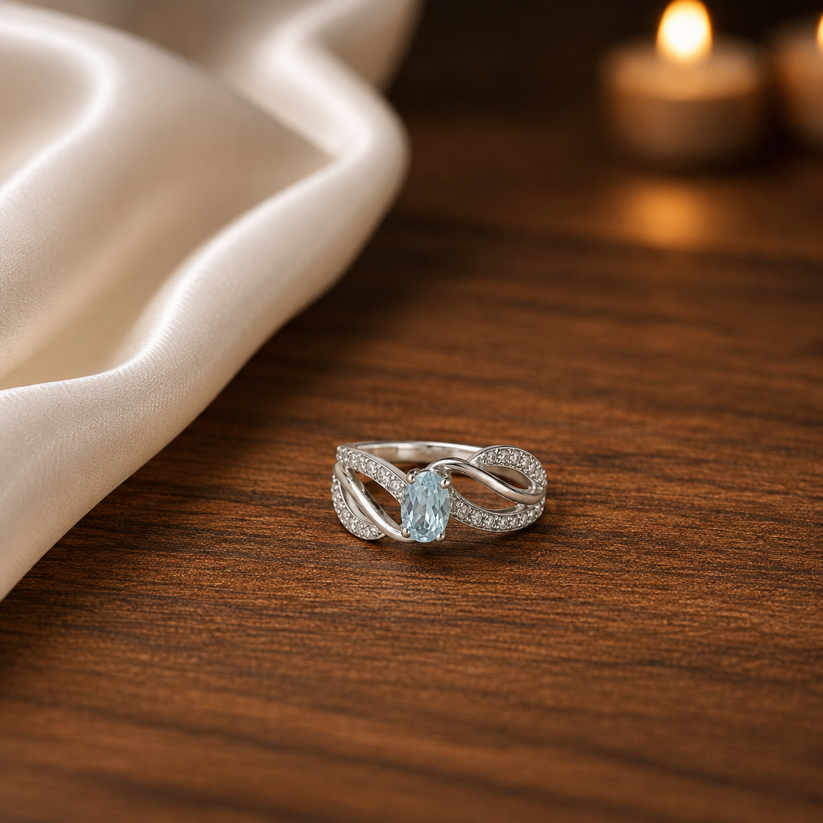 Oval Blue Topaz Ring crafted in 925 Sterling Silver with an oval cut sky blue gemstone and intertwined pavé accented band.