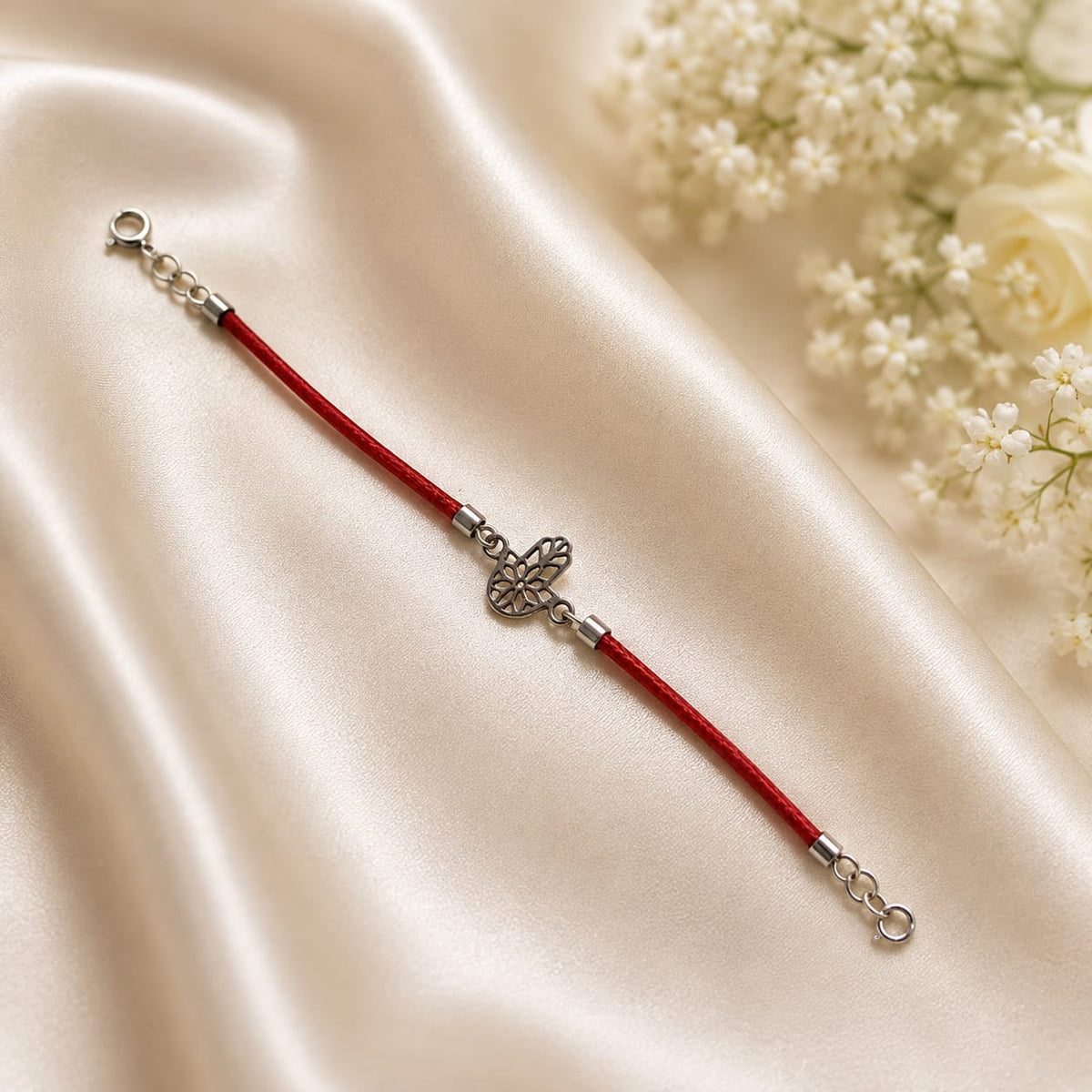 Floral Hamsa charm bracelet on red cord in 925 Silver