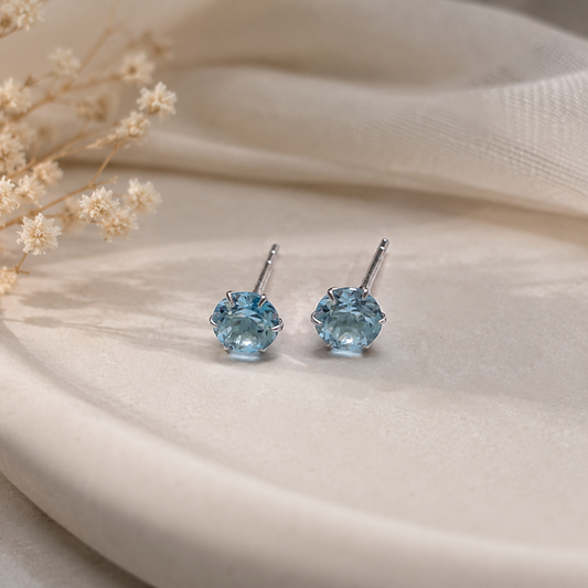 Round Blue Topaz stud earrings in 925 Sterling Silver with six-prong setting
