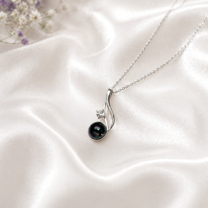 Black Opal Pendant in 925 Sterling Silver with a captivating Black Opal gemstone and sparkling accent stone.