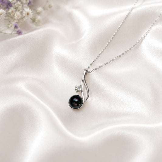 Black Opal Pendant in 925 Sterling Silver with a captivating Black Opal gemstone and sparkling accent stone.