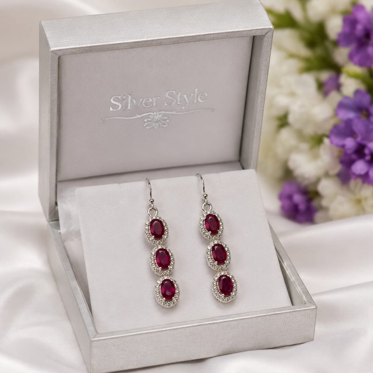 Ruby Triple Drop Earrings in 925 Sterling Silver with oval-cut red gemstones and halo setting.