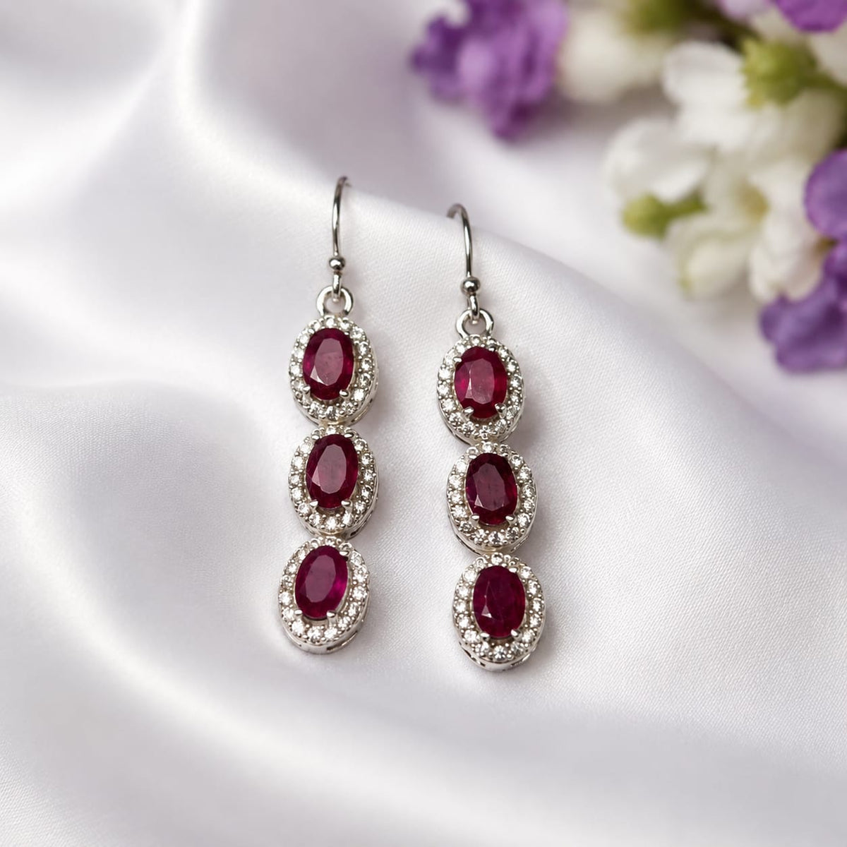 Ruby Triple Drop Earrings in 925 Sterling Silver with oval-cut red gemstones and halo setting.