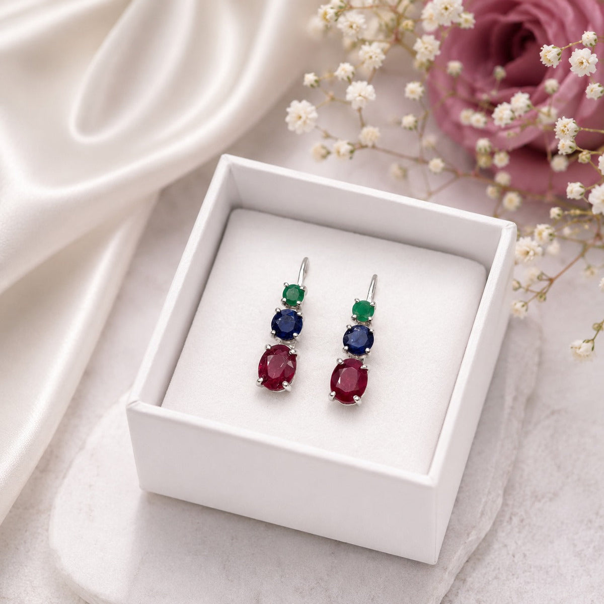 925 Sterling Silver Drop Earrings featuring Emerald, Blue Sapphire, and Ruby gemstones in a vertical three-stone design.