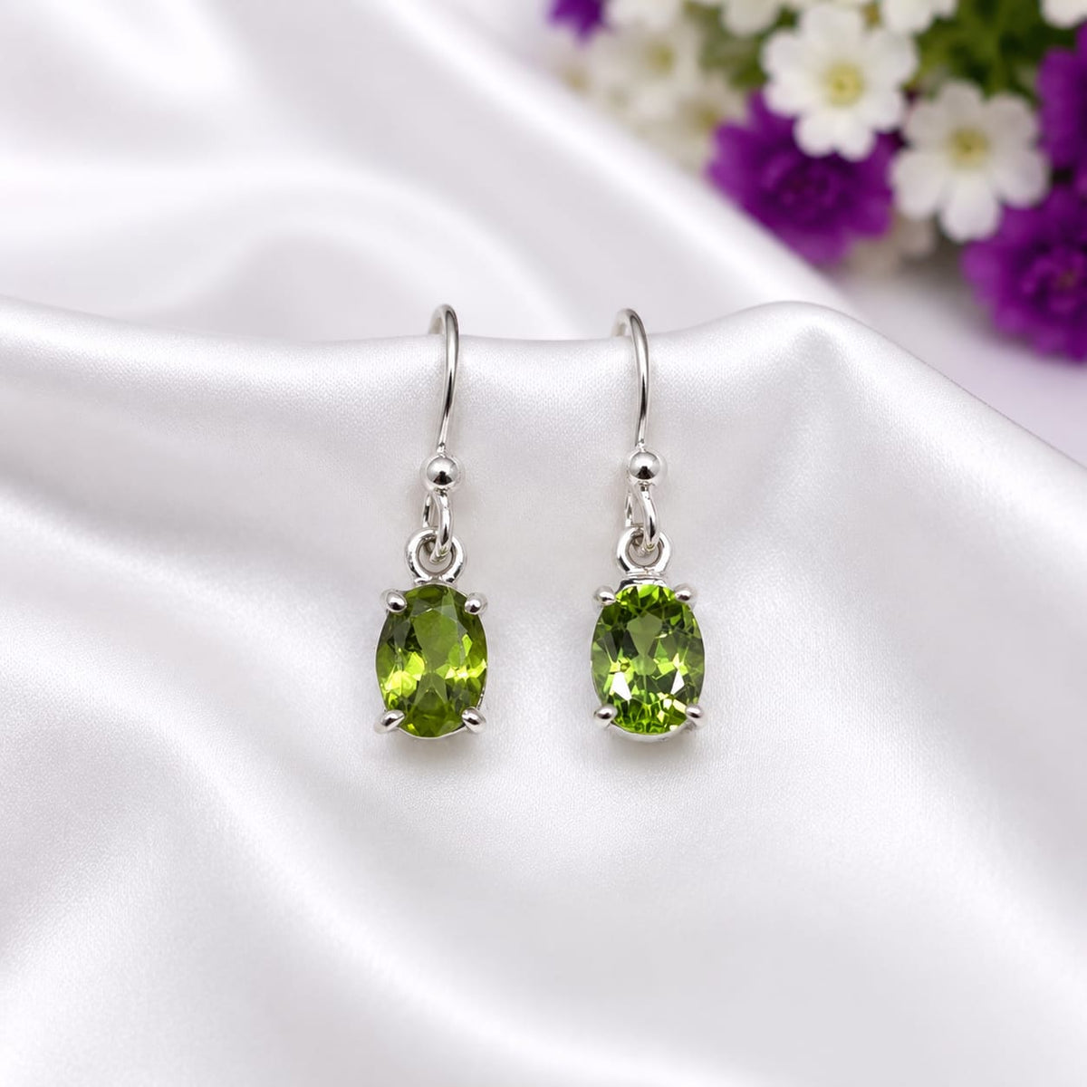 925 Sterling Silver Solitaire Drop Earrings featuring natural oval-cut Peridot gemstones in a classic minimalist setting.