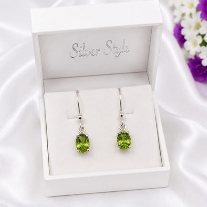 925 Sterling Silver Solitaire Drop Earrings featuring natural oval-cut Peridot gemstones in a classic minimalist setting.