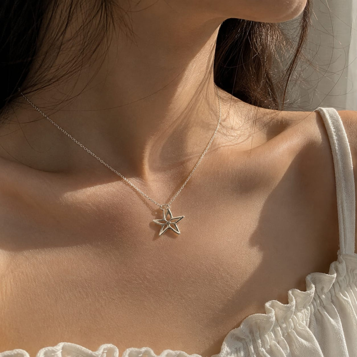 925 Sterling Silver Star Cutout Charm Pendant on Soft Textured Fabric Background