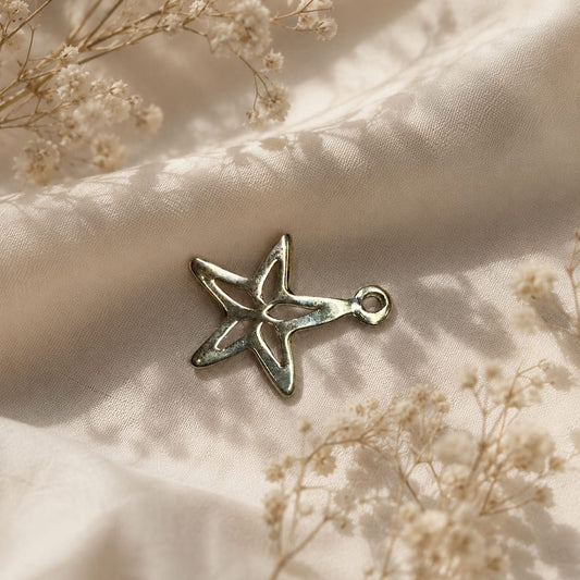 925 Sterling Silver Star Cutout Charm Pendant on Soft Textured Fabric Background