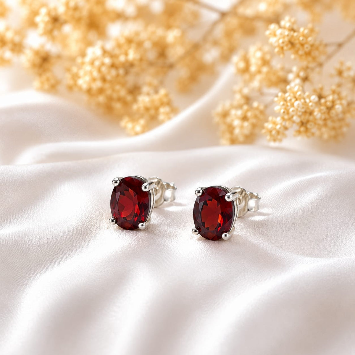 Oval red Garnet ear studs in 925 Sterling Silver with four-prong setting