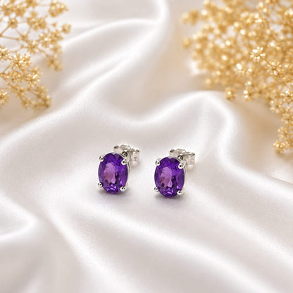 Oval purple Amethyst ear studs in 925 Sterling Silver with four-prong setting