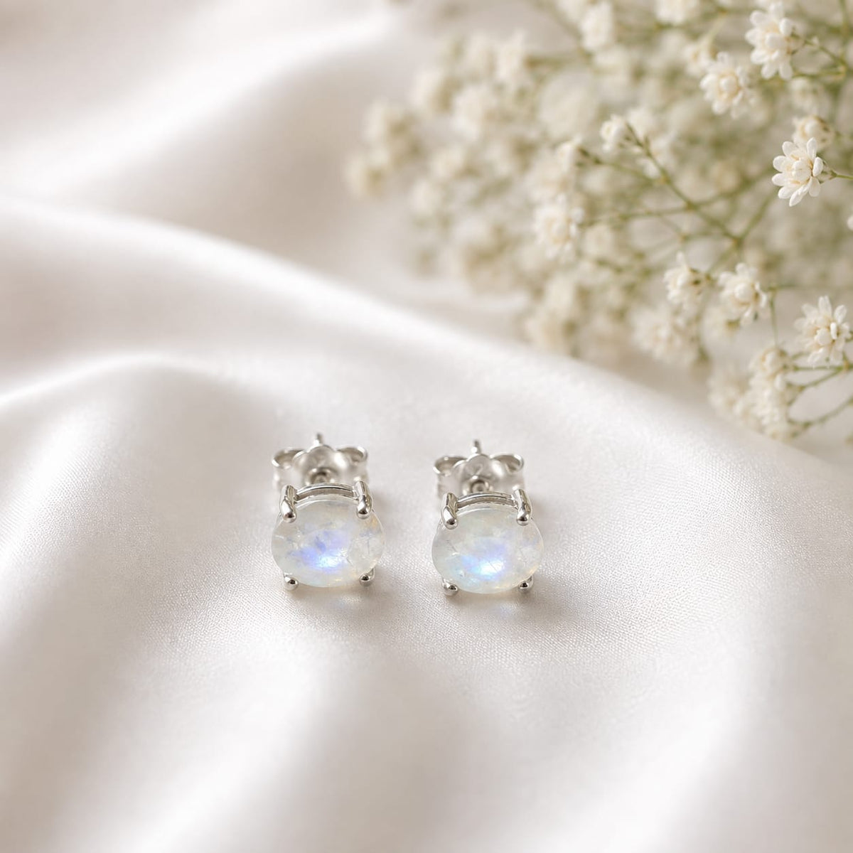 Oval white Moonstone ear studs in 925 Sterling Silver with four-prong setting