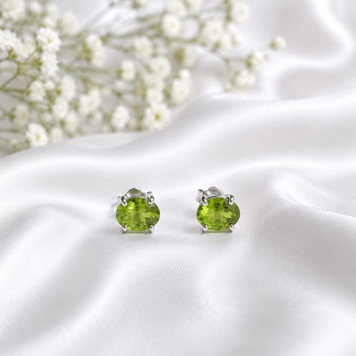 Oval green Peridot ear studs in 925 Sterling Silver with four-prong setting