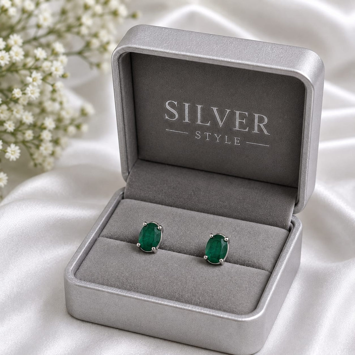 Oval green Emerald ear studs in 925 Sterling Silver with four-prong setting