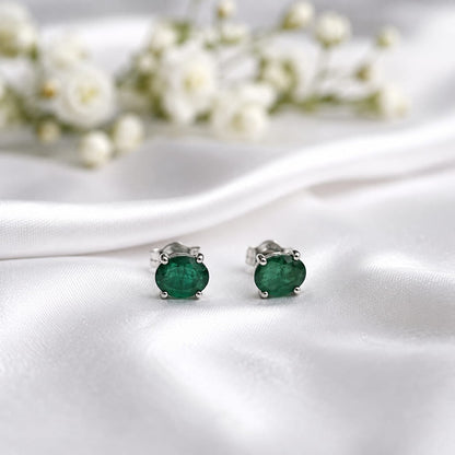 Oval green Emerald ear studs in 925 Sterling Silver with four-prong setting