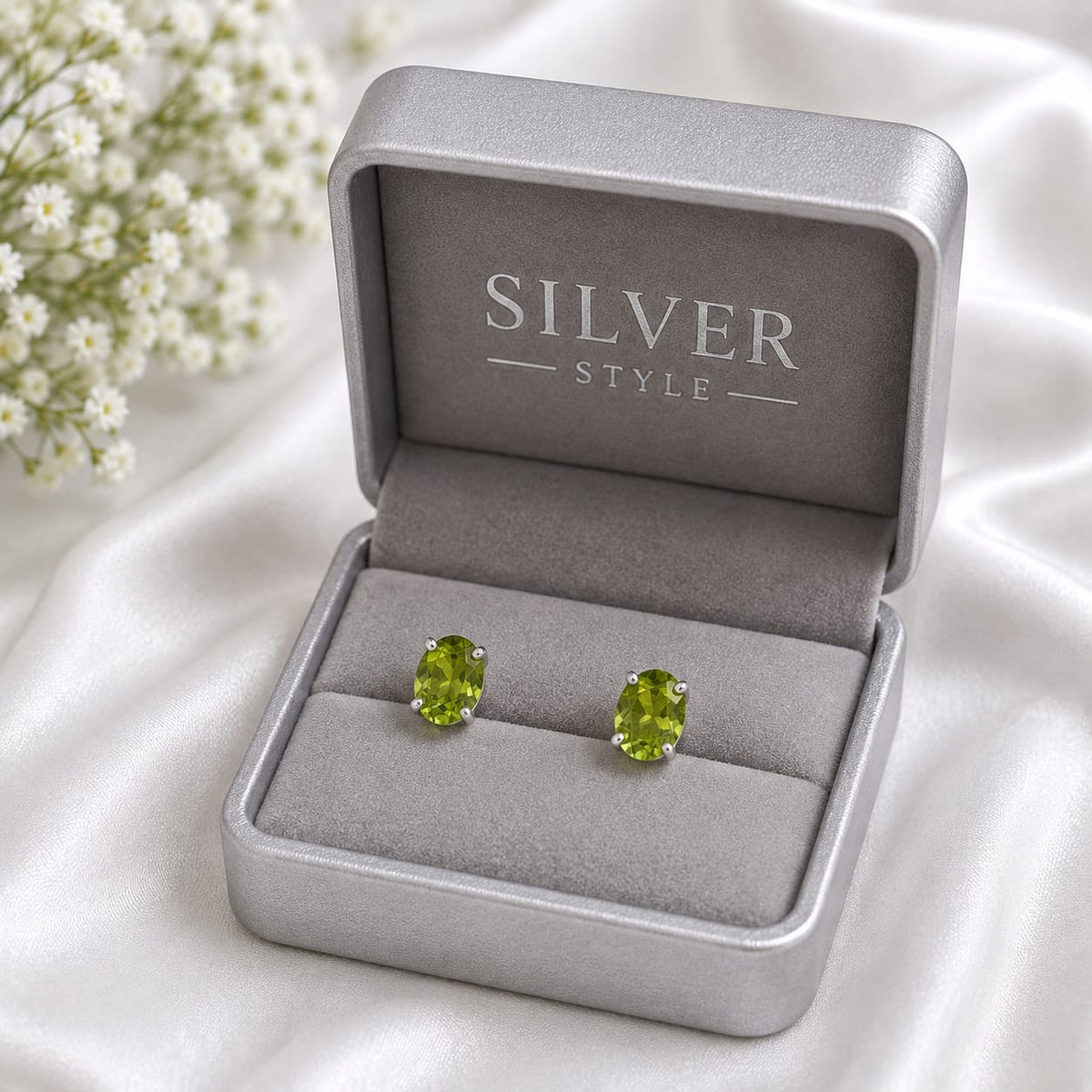 Oval green Peridot ear studs in 925 Sterling Silver with four-prong setting
