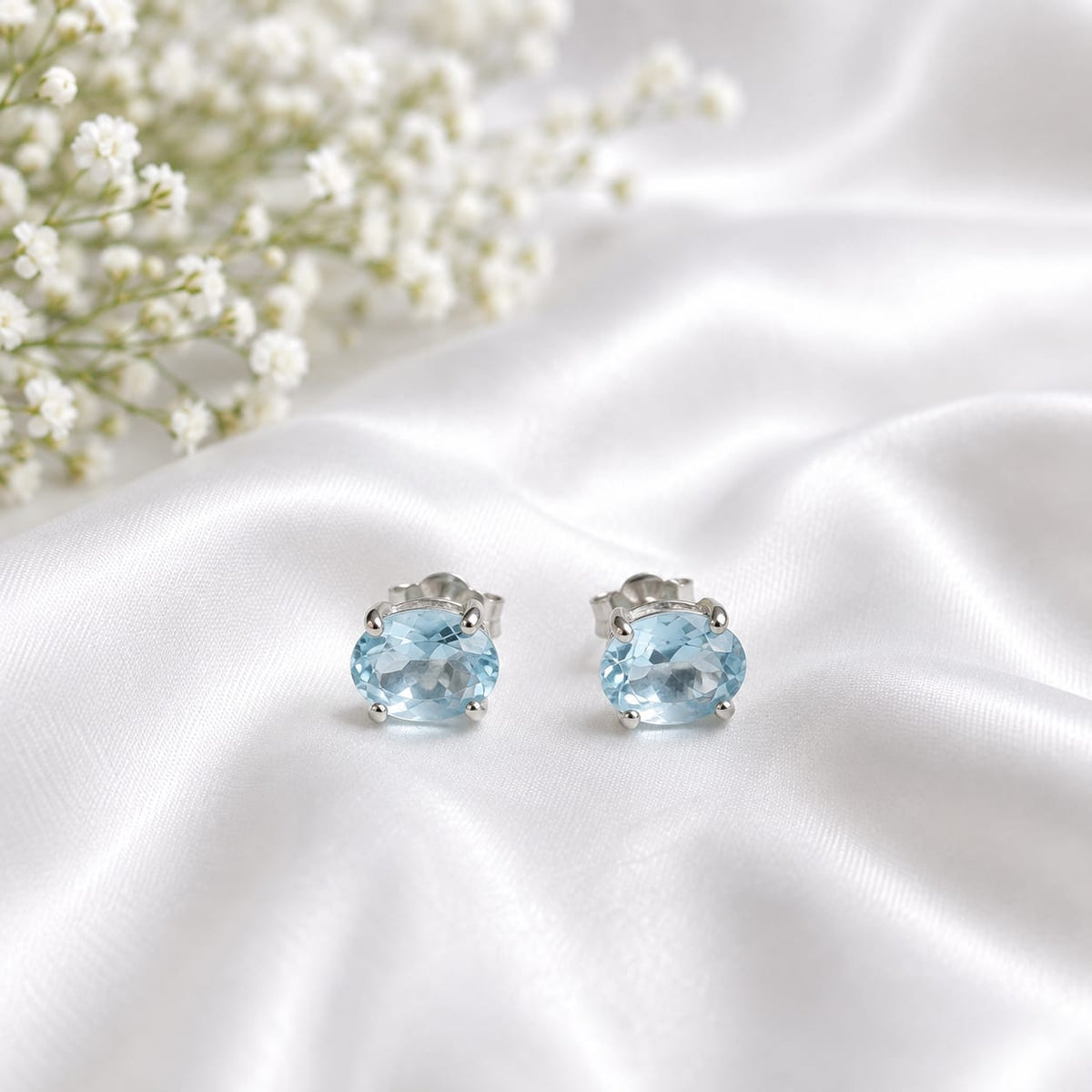 Oval blue Blue Topaz ear studs in 925 Sterling Silver with four-prong setting