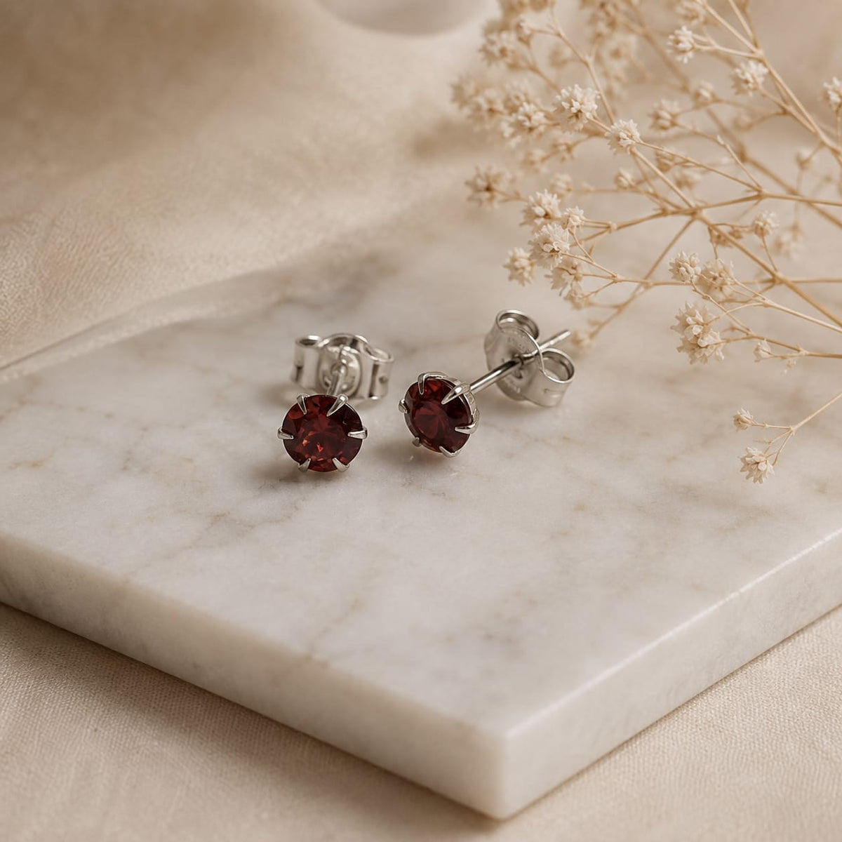 Deep red round Garnet stud earrings in 925 Sterling Silver with six-prong setting
