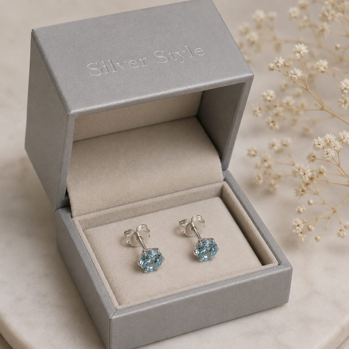 Round Blue Topaz stud earrings in 925 Sterling Silver with six-prong setting