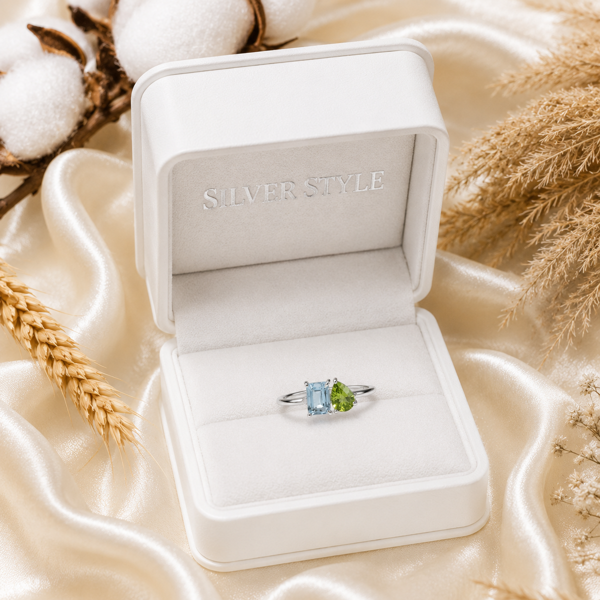 Twin Blue Topaz Ring crafted in 925 Sterling Silver featuring an emerald cut Blue Topaz and pear cut green accent gemstone.