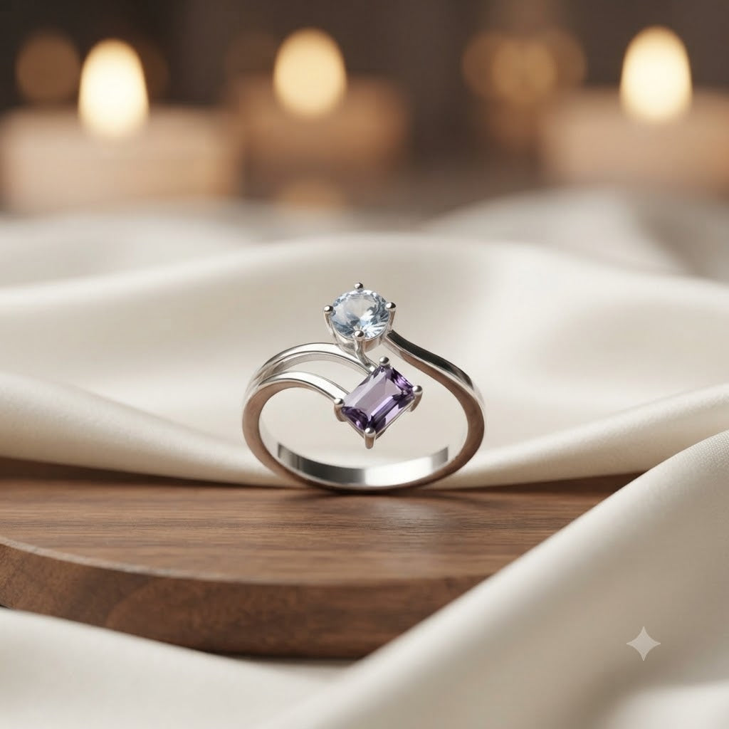 Open Amethyst and Blue Topaz Ring crafted in 925 Sterling Silver featuring an emerald cut Amethyst and pear cut Blue Topaz gemstone.
