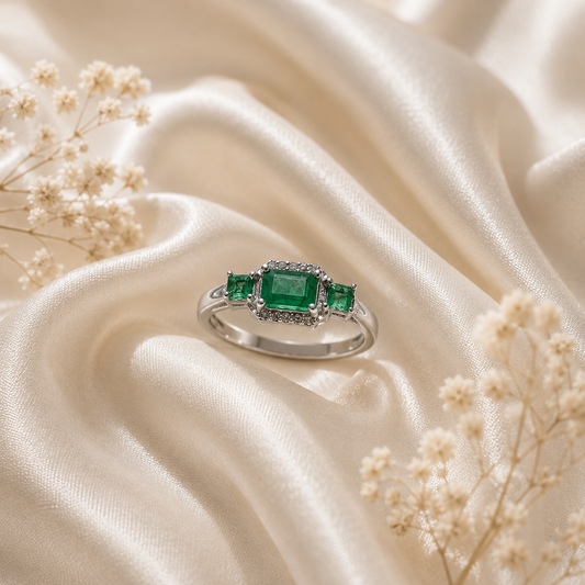 Three Stone Emerald Ring crafted in 925 Sterling Silver with three green Emerald gemstones.
