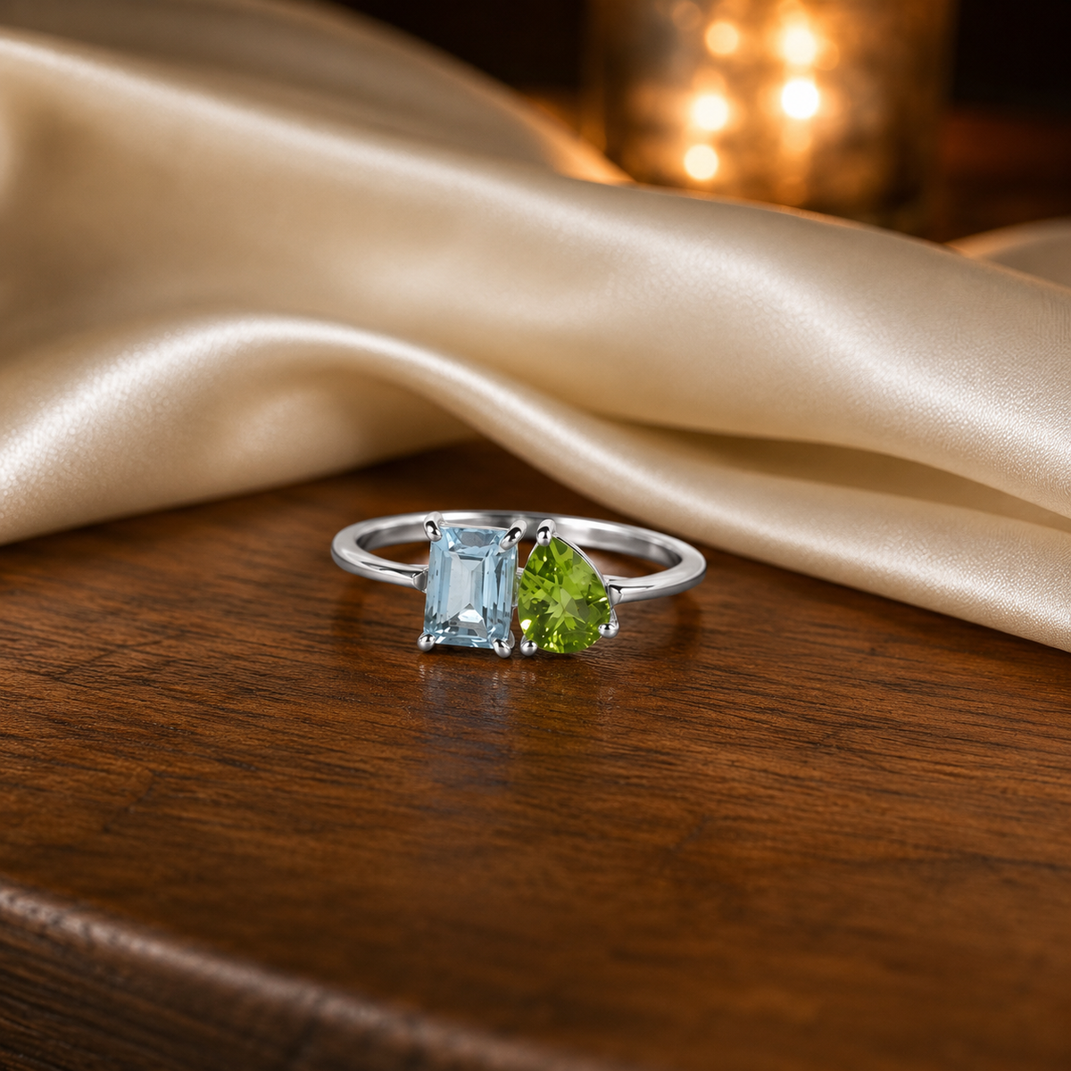 Twin Blue Topaz Ring crafted in 925 Sterling Silver featuring an emerald cut Blue Topaz and pear cut green accent gemstone.
