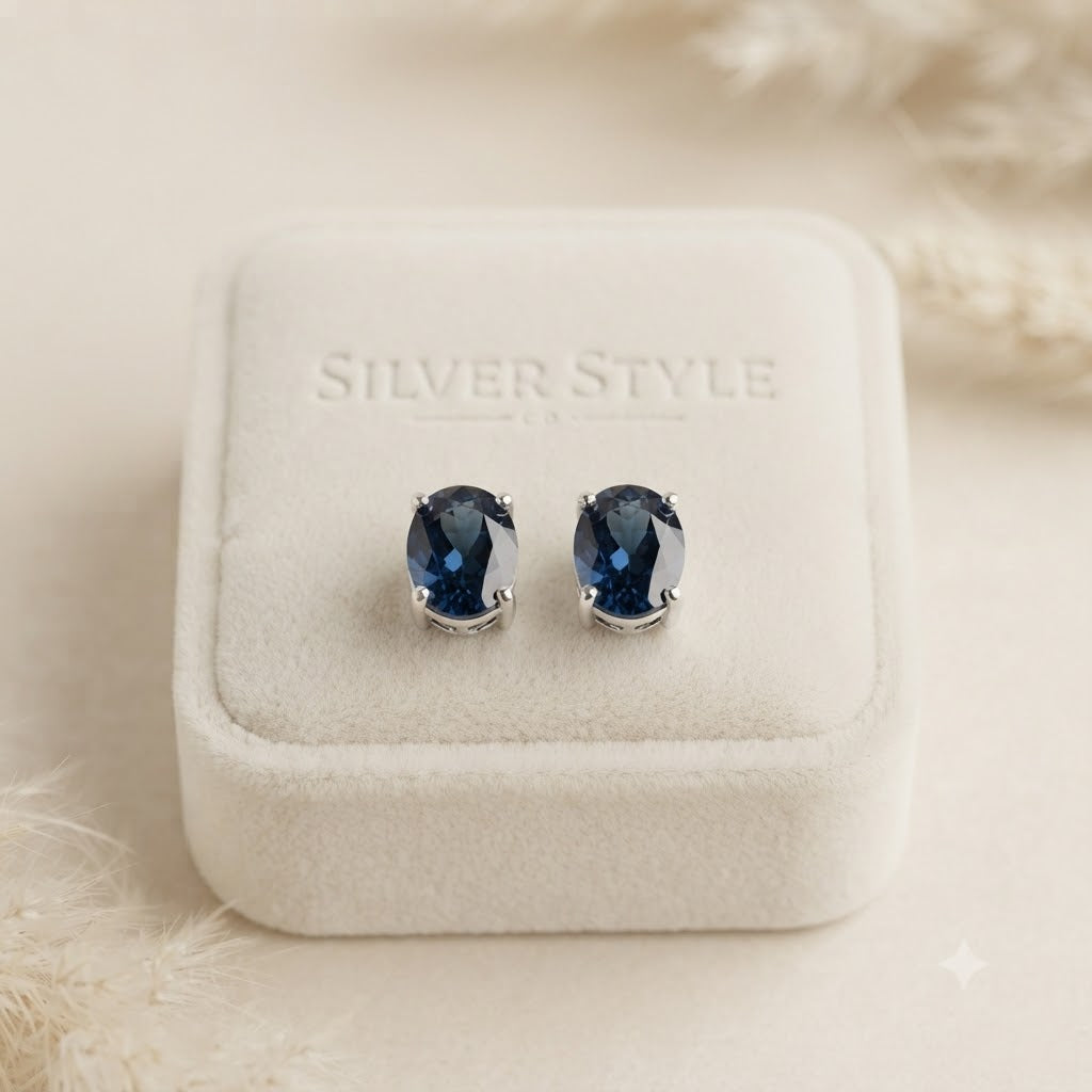 London Blue Topaz stud earrings in 925 sterling silver with oval blue gemstones