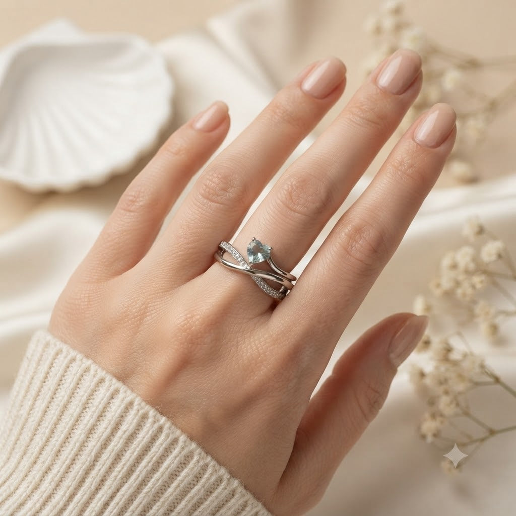 Heart Blue Topaz Ring crafted in 925 Sterling Silver with a heart cut sky blue gemstone and crossover pavé band.