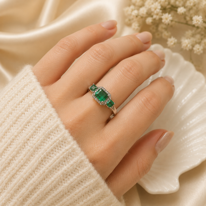 Three Stone Emerald Ring crafted in 925 Sterling Silver with three green Emerald gemstones.