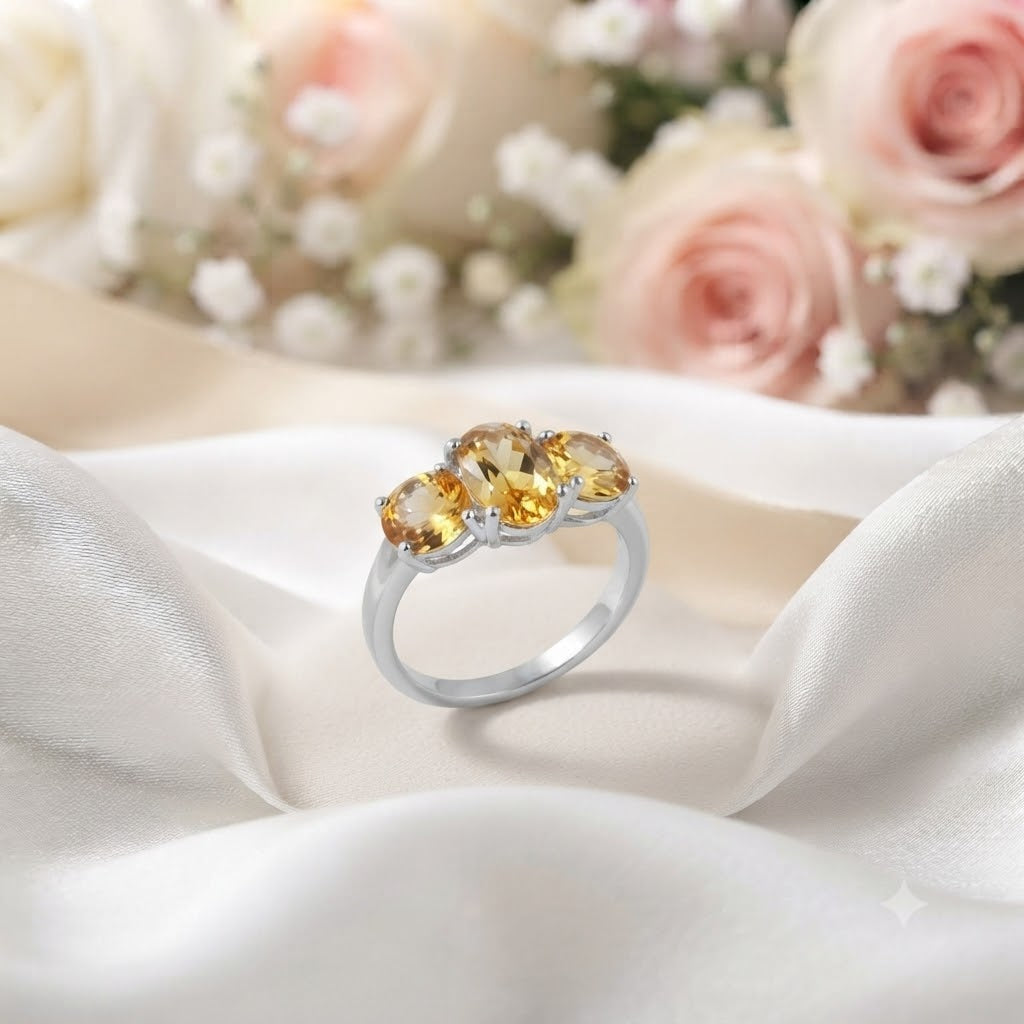 Three Stone Citrine Ring crafted in 925 Sterling Silver featuring three oval cut Citrine gemstones.