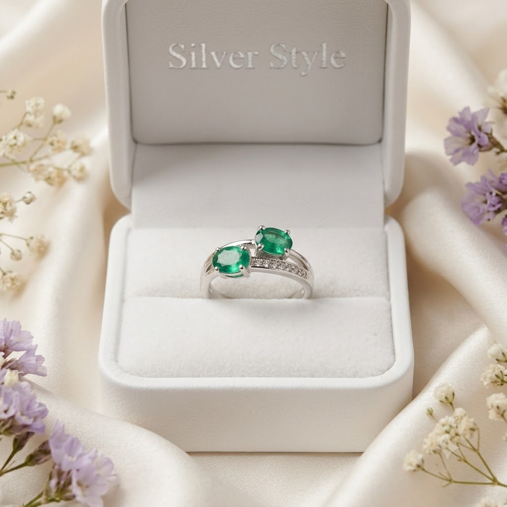 Twin Emerald Ring crafted in 925 Sterling Silver with two green Emerald gemstones.