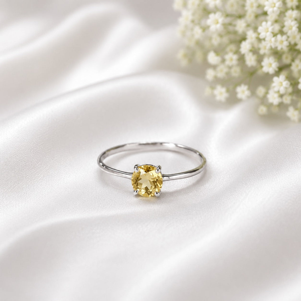 Solitaire Citrine Ring crafted in 925 Sterling Silver featuring a natural round cut Citrine gemstone in a four-prong setting.
