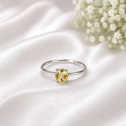 Solitaire Citrine Ring crafted in 925 Sterling Silver featuring a natural round cut Citrine gemstone in a four-prong setting.